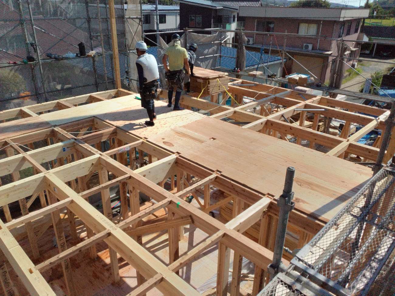 三重で注文住宅ならアイデザインホーム|上棟の現場リポート|2階の床材を施工している職人さんたち