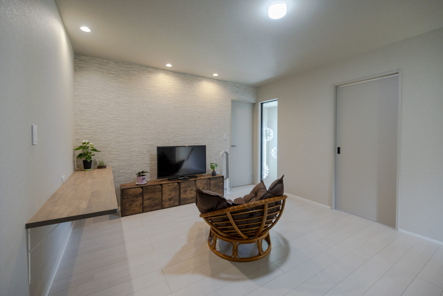 アイデザインホームの施工事例｜家族の距離感が心地よい セカンドリビングのある家｜同居するお母様も気兼ねなく過ごせるよう、2階ホールを広めに設けセカンドリビングに。吹抜けに面した室内窓を覗くと、1階ダイニングでくつろぐ家族の様子が伺えます