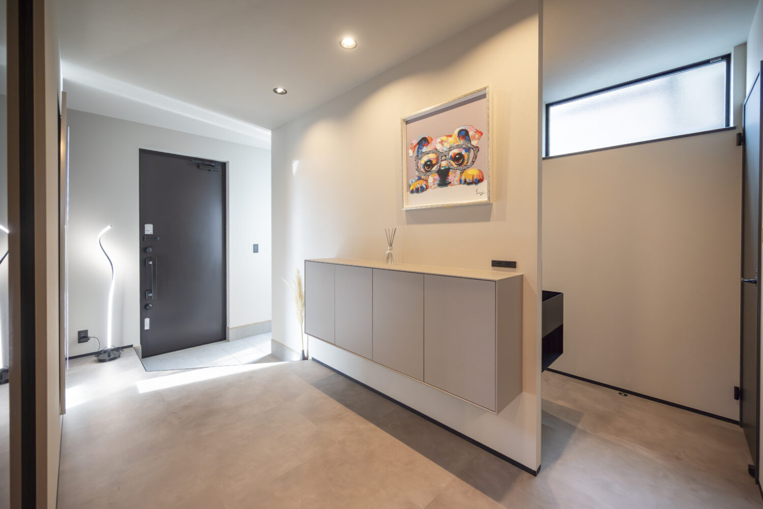 モノトーンで統一されたゆったりとした玄関ホール｜アイデザインホームの施工事例